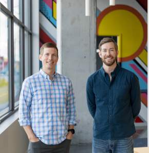Co-founders Brian Forrester and Andrew Miller with a decorative mural behind them