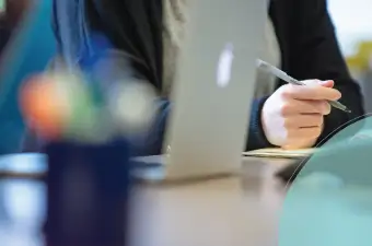 Close up of person writing on notepad