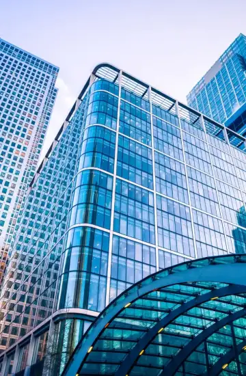 Modern glass office buildings, symbolizing business growth and financial services.