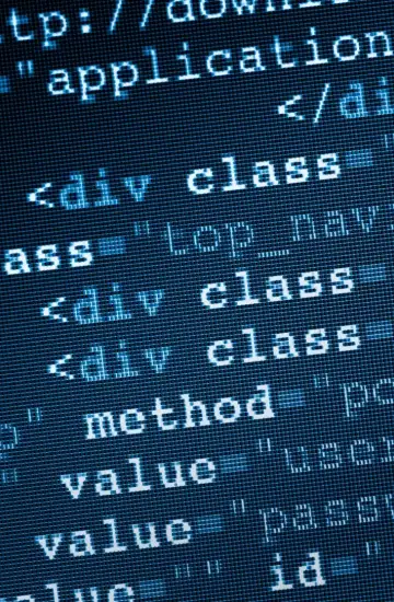 Close-up of HTML code on a screen, highlighting technical SEO and web optimization.