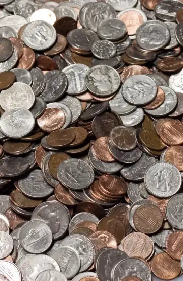 Pile of assorted U.S. coins, symbolizing financial impact and return on investment from paid search and display advertising.