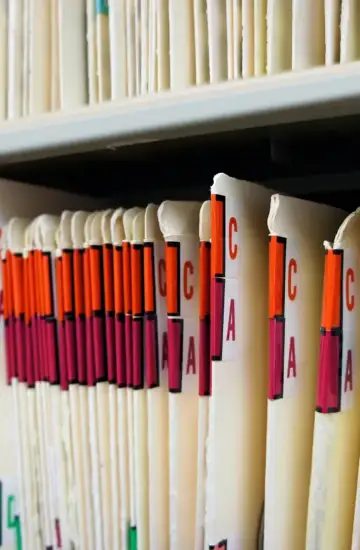 Color-coded patient file folders in a medical office, representing healthcare organization growth through marketing.