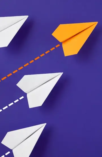 Orange paper plane flying ahead of white ones on a purple background, representing brand differentiation through SEO.