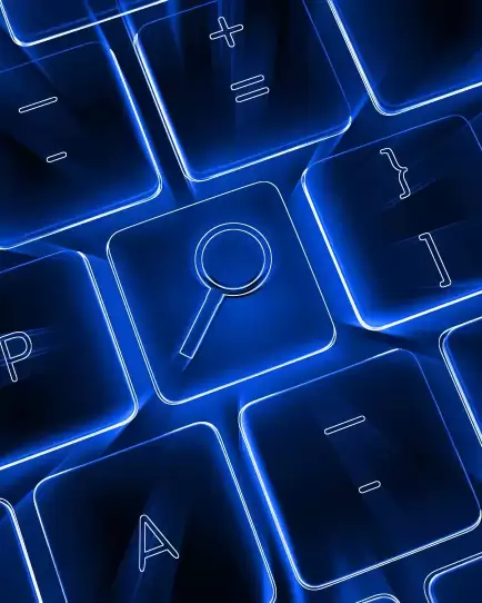 Glowing blue keyboard with a magnifying glass symbol on a key, representing ecommerce SEO and paid search strategy.
