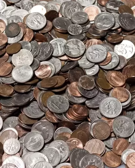 Pile of assorted U.S. coins, symbolizing financial impact and return on investment from paid search and display advertising.