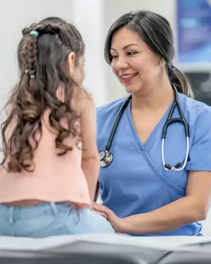 Smiling healthcare provider with a young patient in a clinical setting, representing increased brand trust in healthcare.