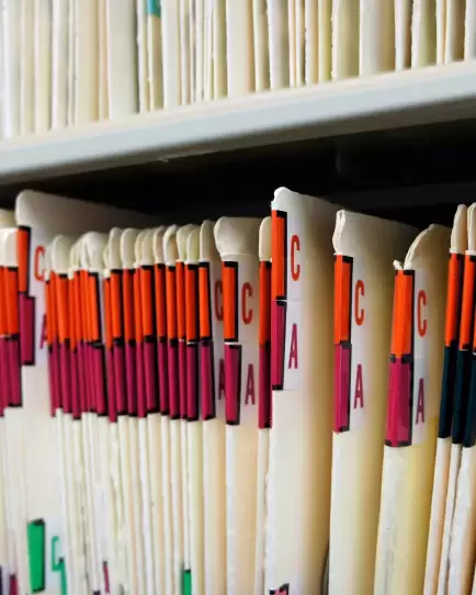 Color-coded patient file folders in a medical office, representing healthcare organization growth through marketing.
