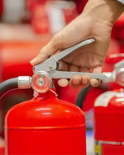 Person’s hand gripping the handle of a red fire extinguisher, symbolizing growth through digital marketing.