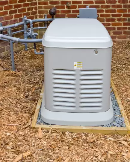 Outdoor standby generator installed next to a brick building, symbolizing reliable infrastructure and long-term ROI.