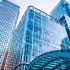 Modern glass office buildings, symbolizing business growth and financial services.