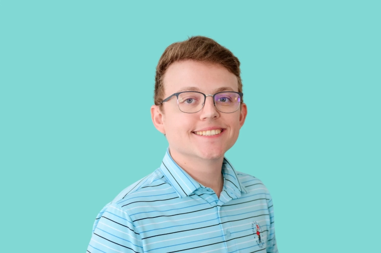 Portrait of Alex Murphy on a teal background.