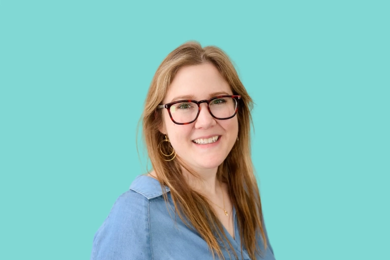 Portrait of Amy Blum on a teal background.