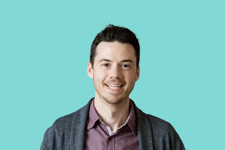 Portrait of Chris LaRoche on a teal background.