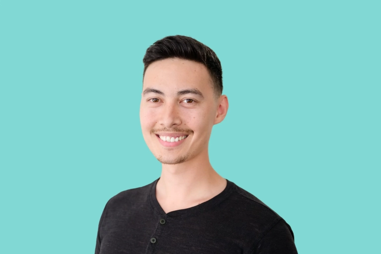 Portrait of Chris Mah on a teal background.