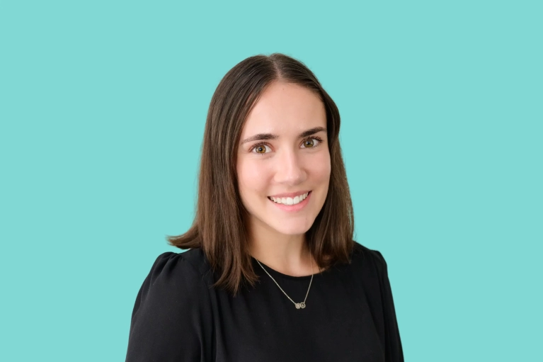 Portrait of Erica Wirth on a teal background.