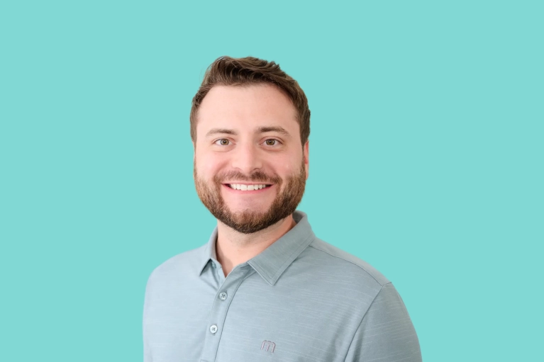 Portrait of Josh Shapiro on a teal background.