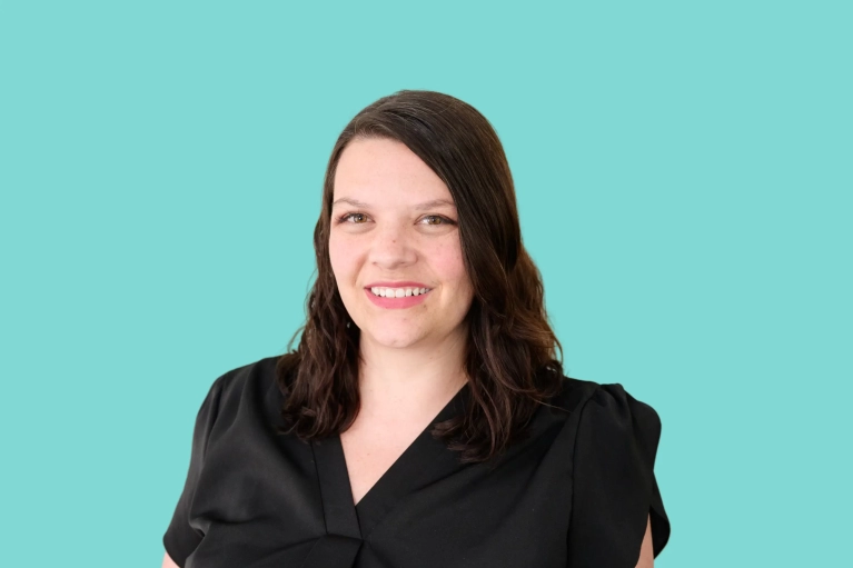 Portrait of Julie Kalita on a teal background.