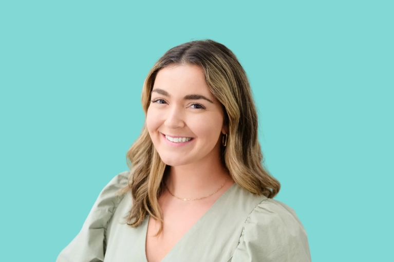 Portrait of Nicole Wright on a teal background.