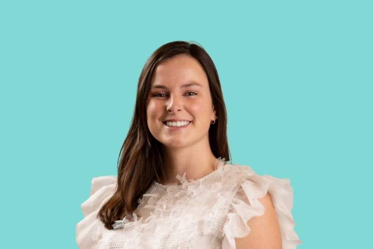 Portrait of Reilly Phelps on a teal background.