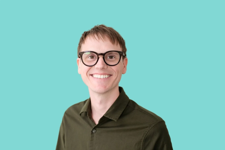 Portrait of Scott Miller on a teal background.